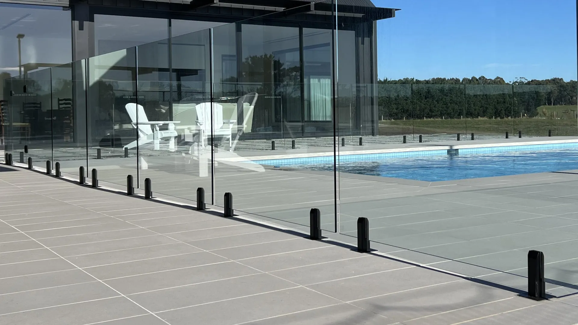 Non-Conductive Spigots in Matte Black on Glass Pool Fence